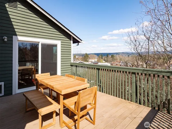 a balcony with table and chairs