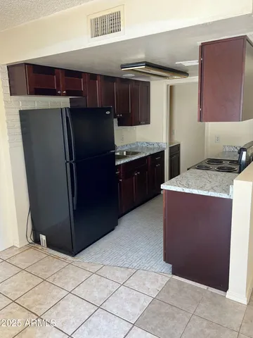 a kitchen with stainless steel appliances granite countertop a refrigerator and a stove