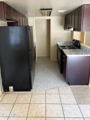 a kitchen with stainless steel appliances a refrigerator and a stove