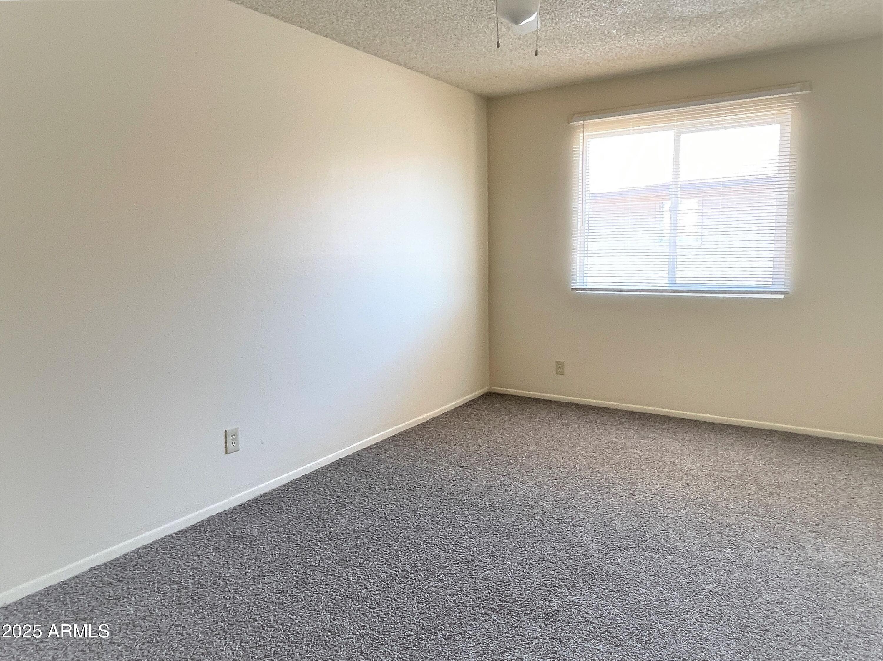 4718 East Portland Street Phoenix, AZ 85008 - Photo 7 of 11 an empty room with a window