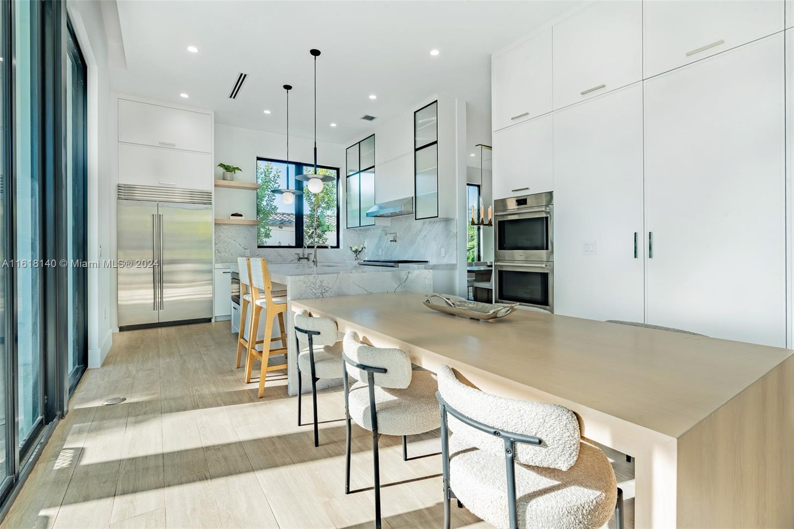 9000 Abbott Avenue Surfside, FL 33154 - Photo 15 of 82 a kitchen with kitchen island a large counter top space appliances and cabinets