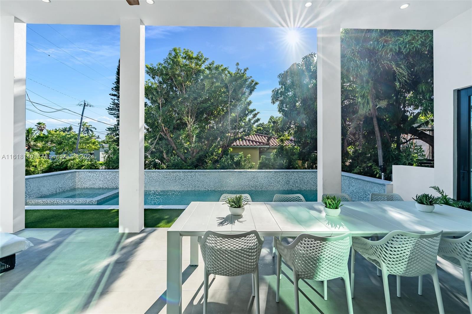 9000 Abbott Avenue Surfside, FL 33154 - Photo 24 of 82 a view of an outdoor dining space with a table and chairs