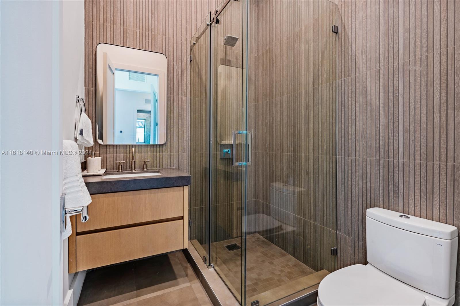 9000 Abbott Avenue Surfside, FL 33154 - Photo 42 of 82 a bathroom with a toilet a sink and shower