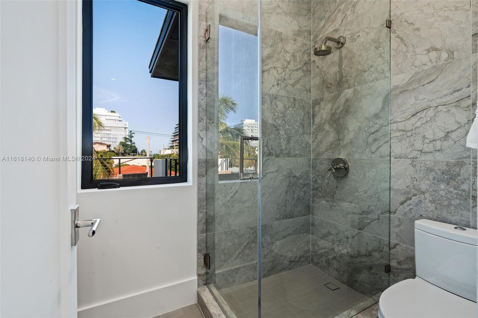 9000 Abbott Avenue Surfside, FL 33154 - Photo 51 of 82 a bathroom with a toilet and shower