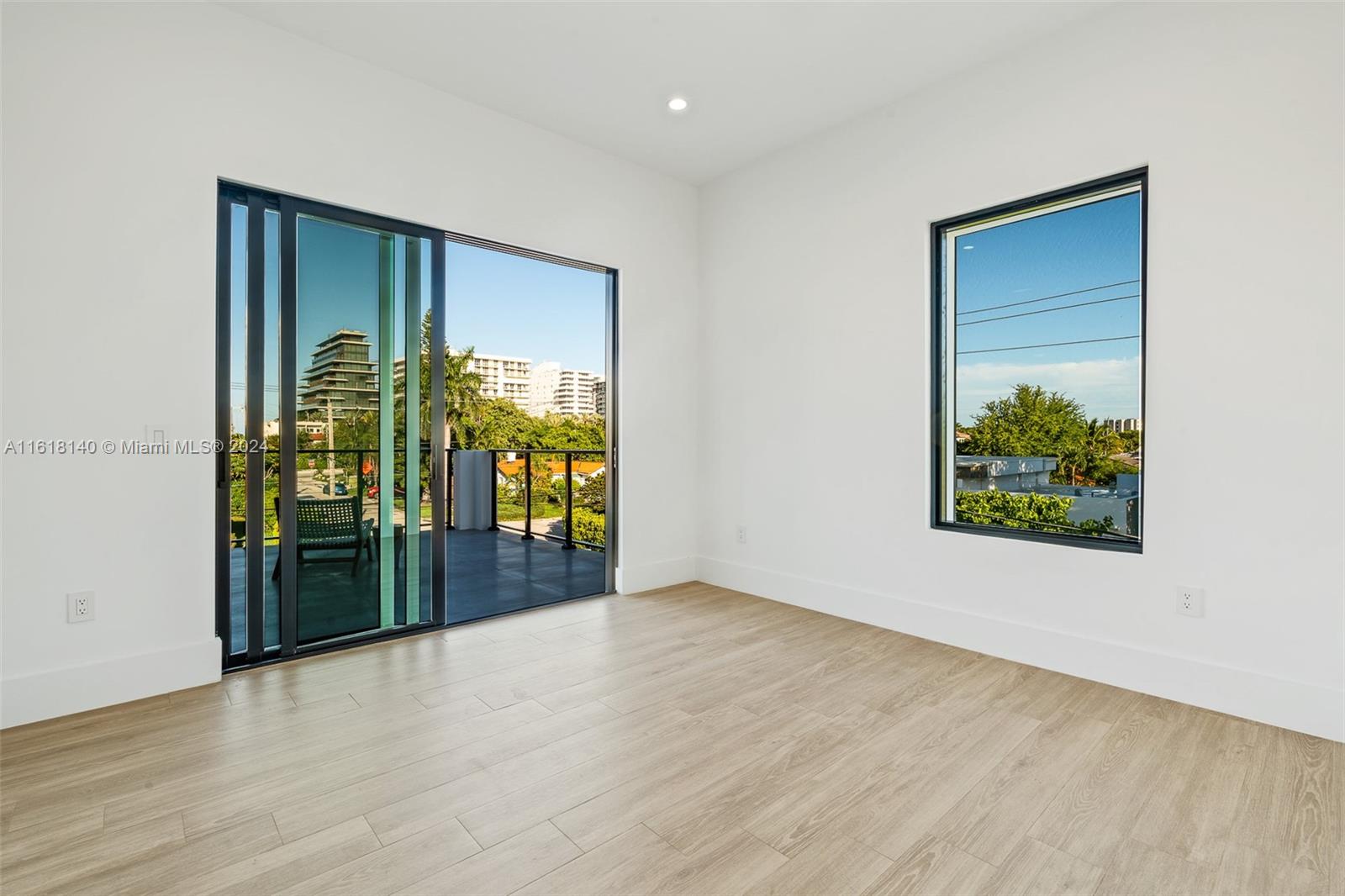 9000 Abbott Avenue Surfside, FL 33154 - Photo 56 of 82 wooden floor in an empty room with a window