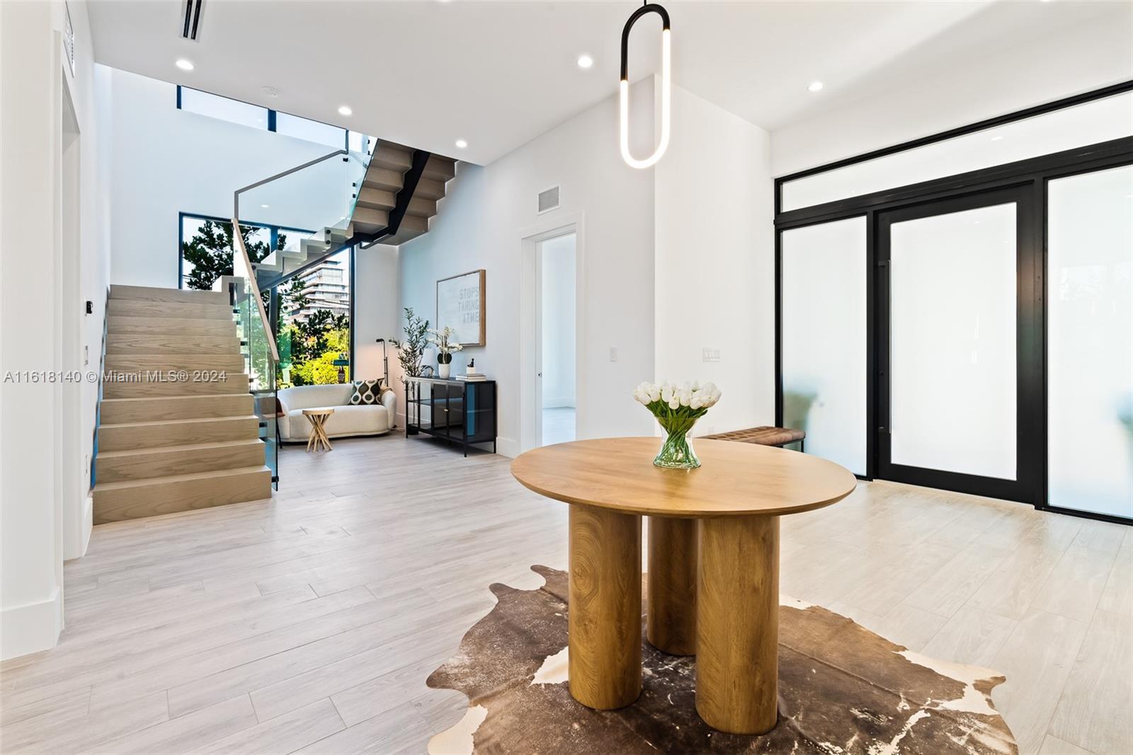 9000 Abbott Avenue Surfside, FL 33154 - Photo 6 of 82 a view of entryway and hall with wooden floor