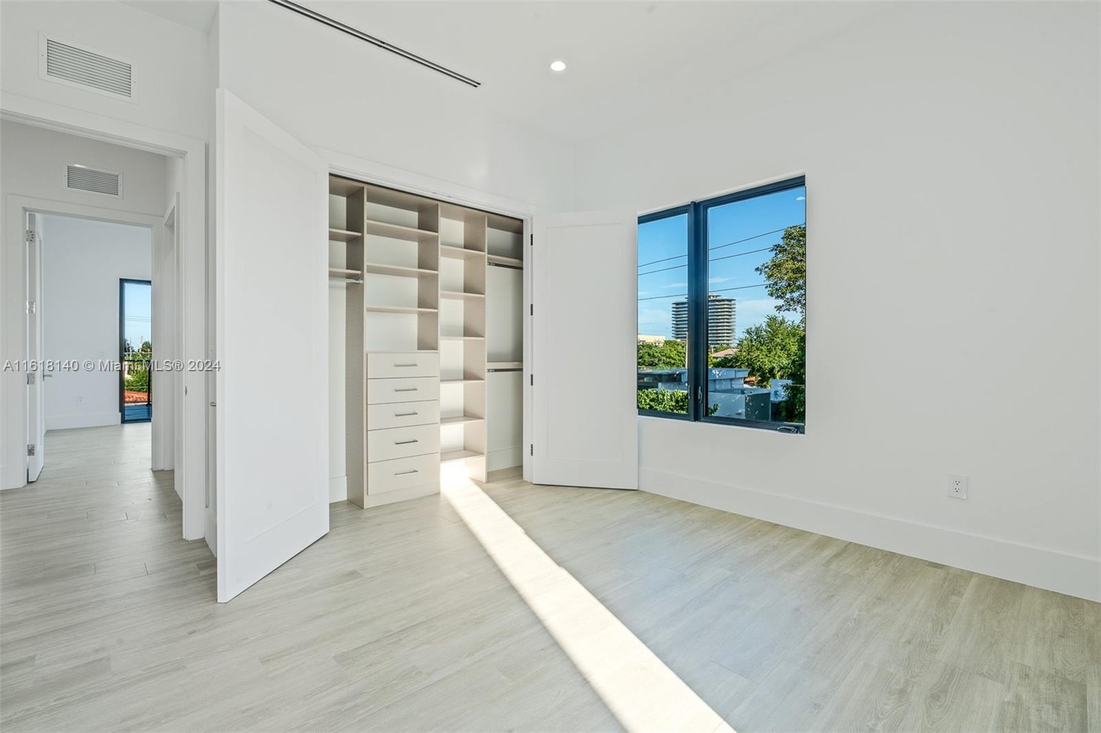 9000 Abbott Avenue Surfside, FL 33154 - Photo 63 of 82 an empty room with wooden floor and windows
