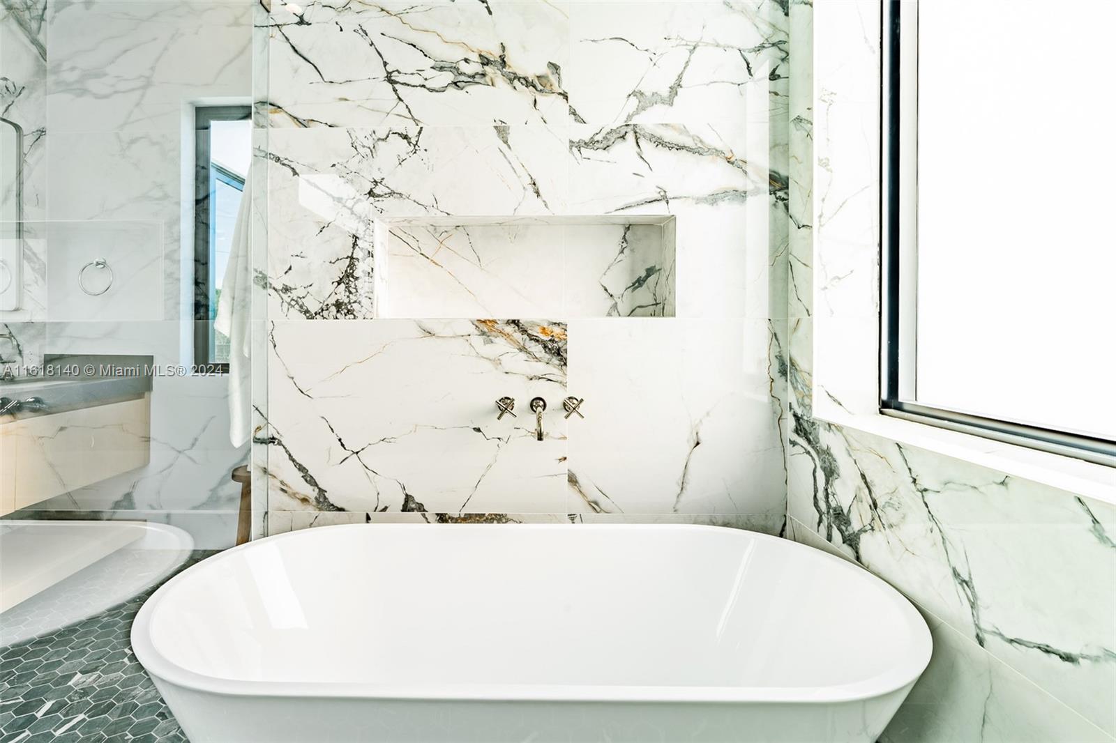 9000 Abbott Avenue Surfside, FL 33154 - Photo 70 of 82 a white bath tub sitting in a bathroom