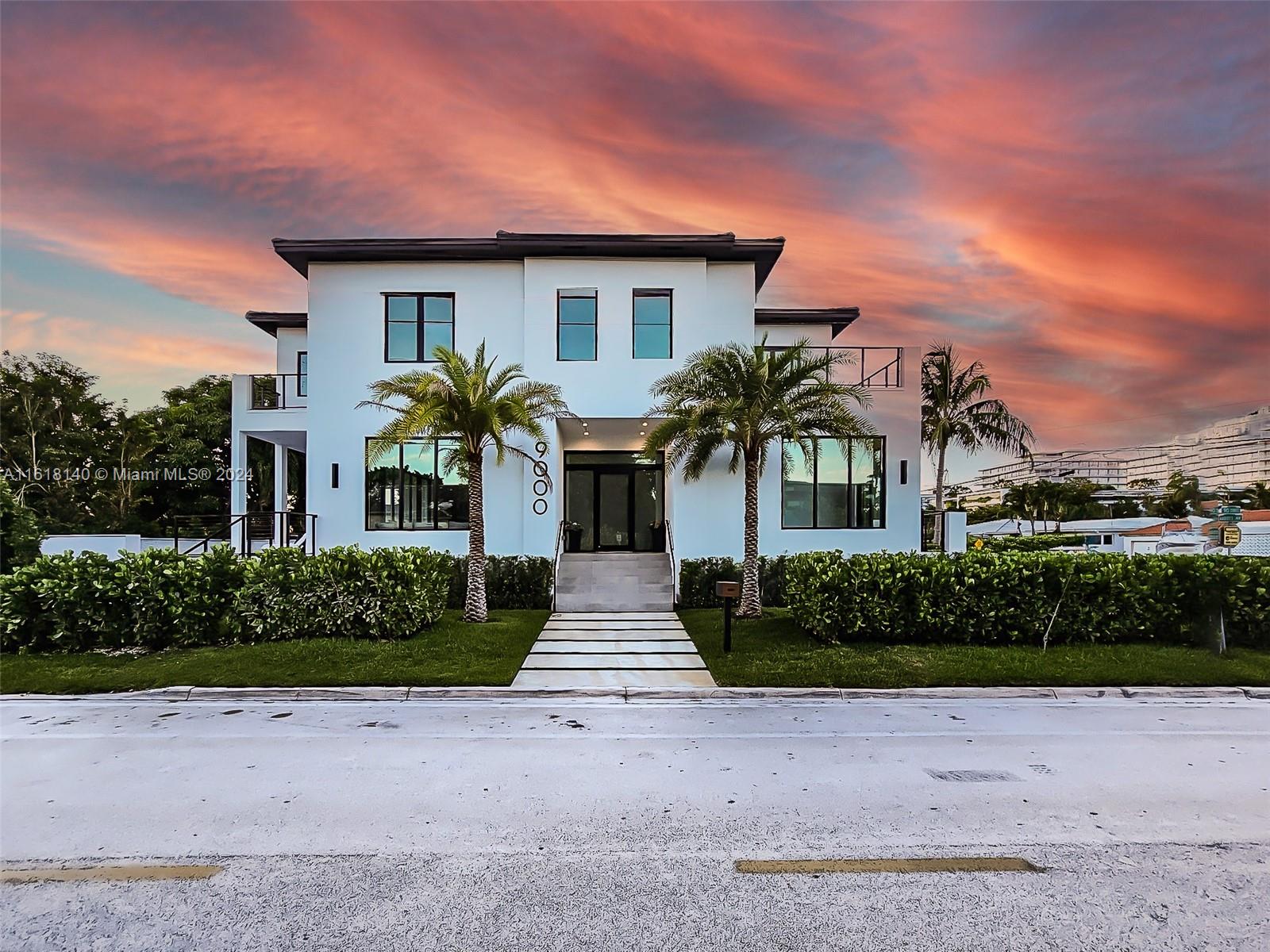 9000 Abbott Avenue Surfside, FL 33154 - Photo 81 of 82 a front view of a house with a yard and a garage