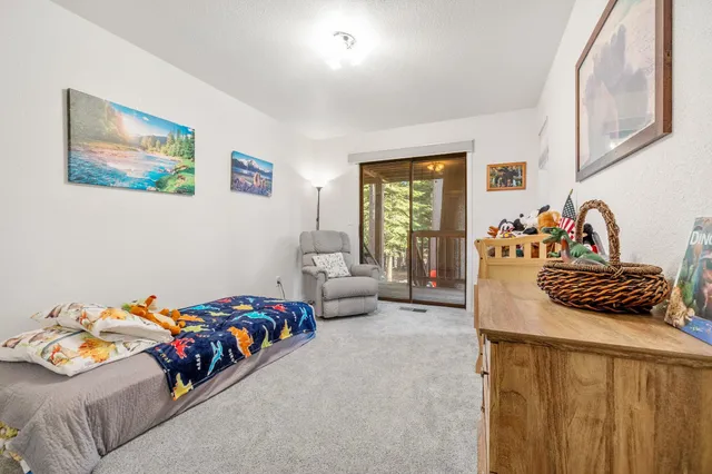 a bedroom with a bed and a couch