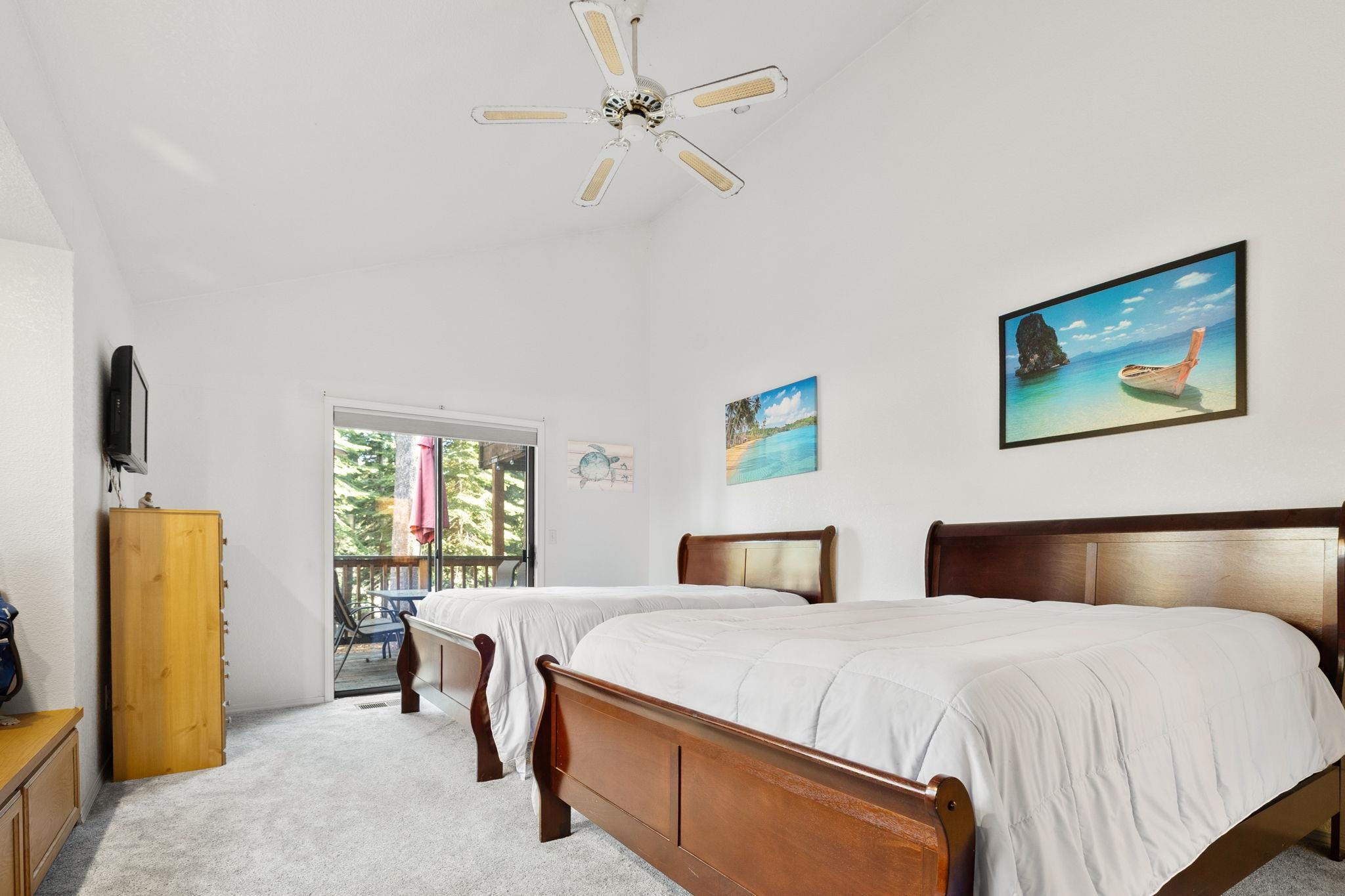 50689 Conifer Drive Soda Springs, CA 95728 - Photo 15 of 28 a bedroom with a large bed and a chandelier