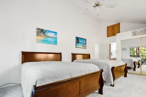 a bedroom with a bed and ceiling fan