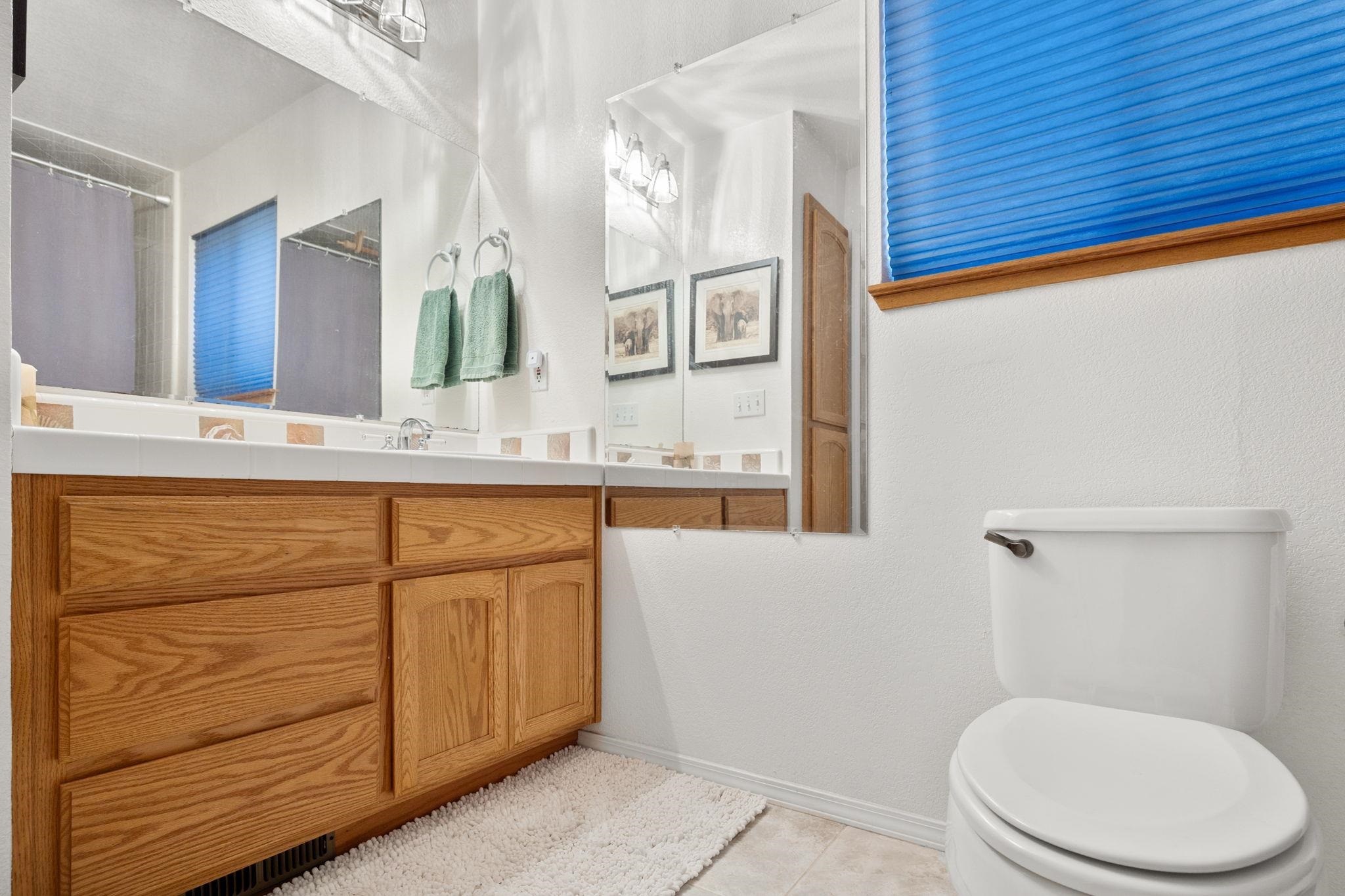 50689 Conifer Drive Soda Springs, CA 95728 - Photo 17 of 28 a bathroom with a granite countertop toilet sink and mirror