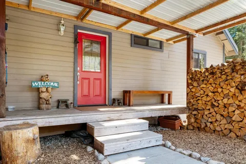 a view of a house with couches chairs and wooden floor