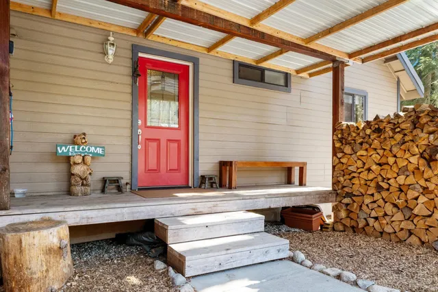 a view of a house with couches chairs and wooden floor