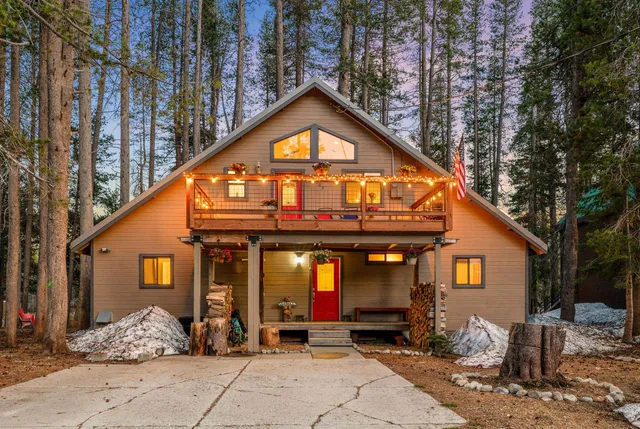 a view of outdoor dining space in the backyard of a house