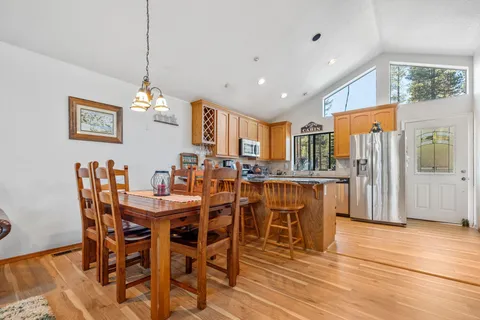 a view of a dining room with furniture and chandelier