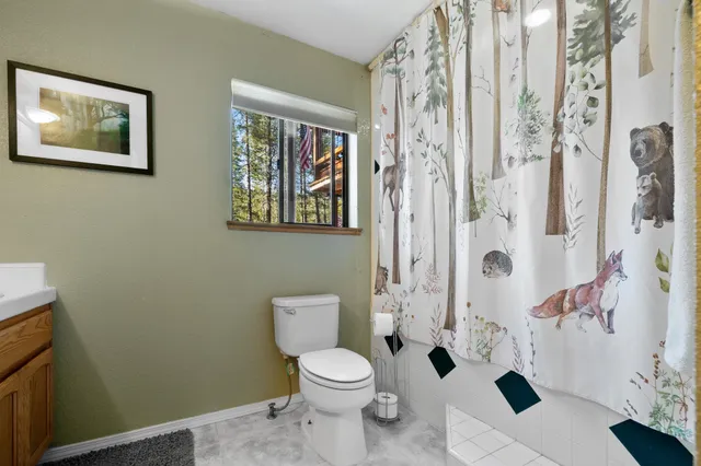 a white toilet sitting next to a bathroom sink