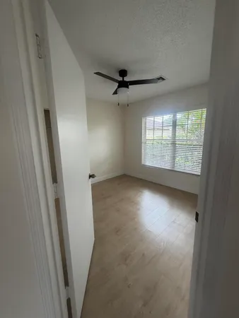 an empty room with windows and entrance