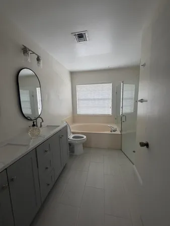 a bathroom with a bathtub sink and toilet