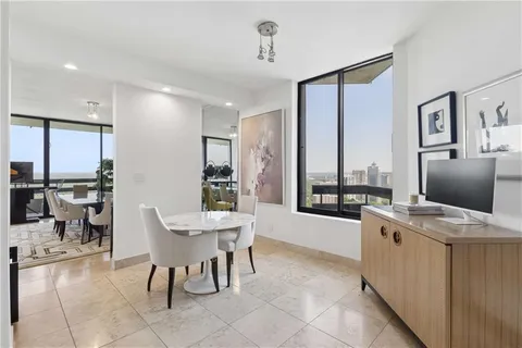 a dining room with furniture and a window