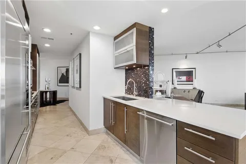a kitchen with stainless steel appliances a sink stove and refrigerator