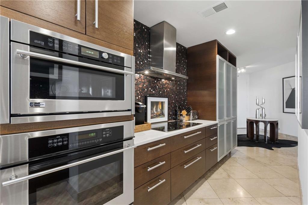 2660 Peachtree Road Northwest, Unit 39D Atlanta, GA 30305 - Photo 18 of 45 a kitchen with stainless steel appliances and cabinets