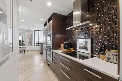 a kitchen with stainless steel appliances kitchen island granite countertop a sink and cabinets