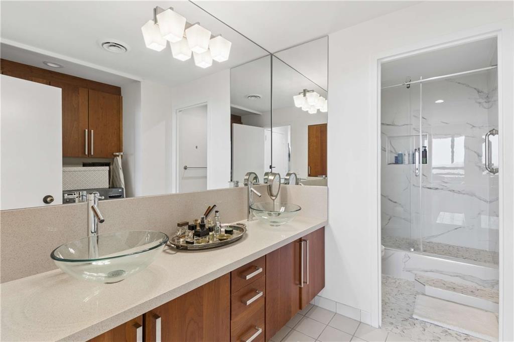 2660 Peachtree Road Northwest, Unit 39D Atlanta, GA 30305 - Photo 25 of 45 a bathroom with a sink and a mirror