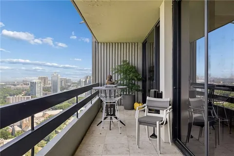 a balcony with furniture and a potted plant