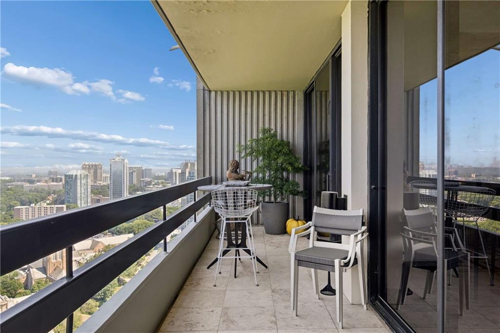 2660 Peachtree Road Northwest, Unit 39D Atlanta, GA 30305 - Photo 31 of 45 a balcony with furniture and a potted plant