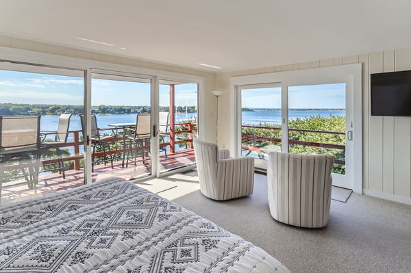 217 Barnes Road Oak Bluffs, MA 02557 - Photo 10 of 60 The primary bedroom features a private deck with spectacular water views of the Lagoon and Vineyard Sound
