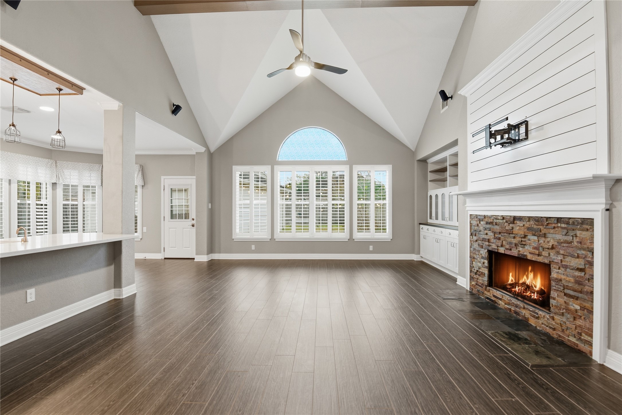 3130 Red Maple Drive Friendswood, TX 77546 - Photo 4 of 26 a view of an empty room with wooden floor fireplace and a window
