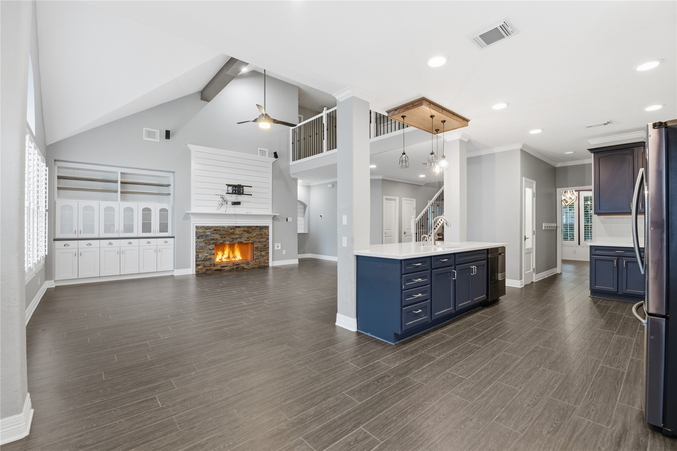 3130 Red Maple Drive Friendswood, TX 77546 - Photo 6 of 26 a large living room with a fireplace and wooden floors