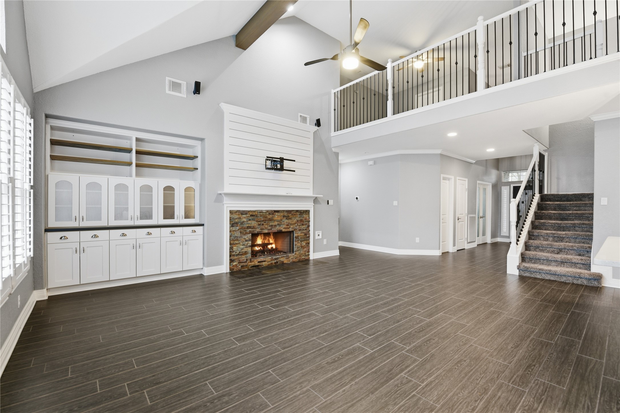 3130 Red Maple Drive Friendswood, TX 77546 - Photo 9 of 26 a view of an empty room with wooden floor fireplace and a window