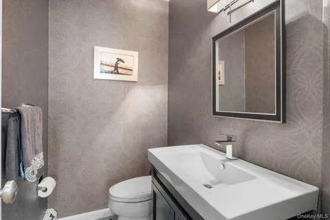 a living room with a baby crib and a flat screen tv