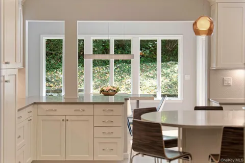 a kitchen with stainless steel appliances granite countertop a sink and a refrigerator