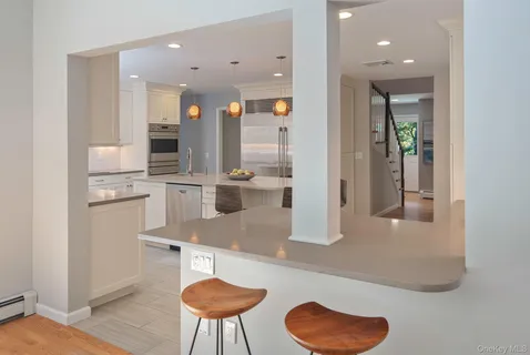 a dining room with furniture a chandelier and wooden floor