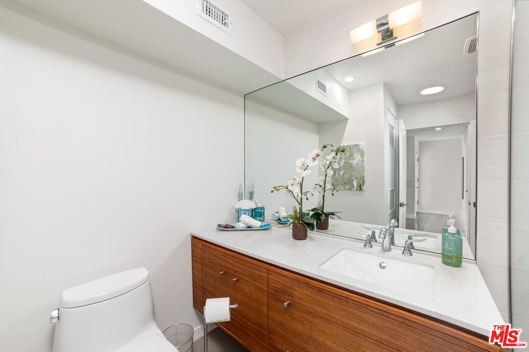 975 East Sunny Dunes Road Palm Springs, CA 92264 - Photo 17 of 40 a bathroom with a sink and a mirror