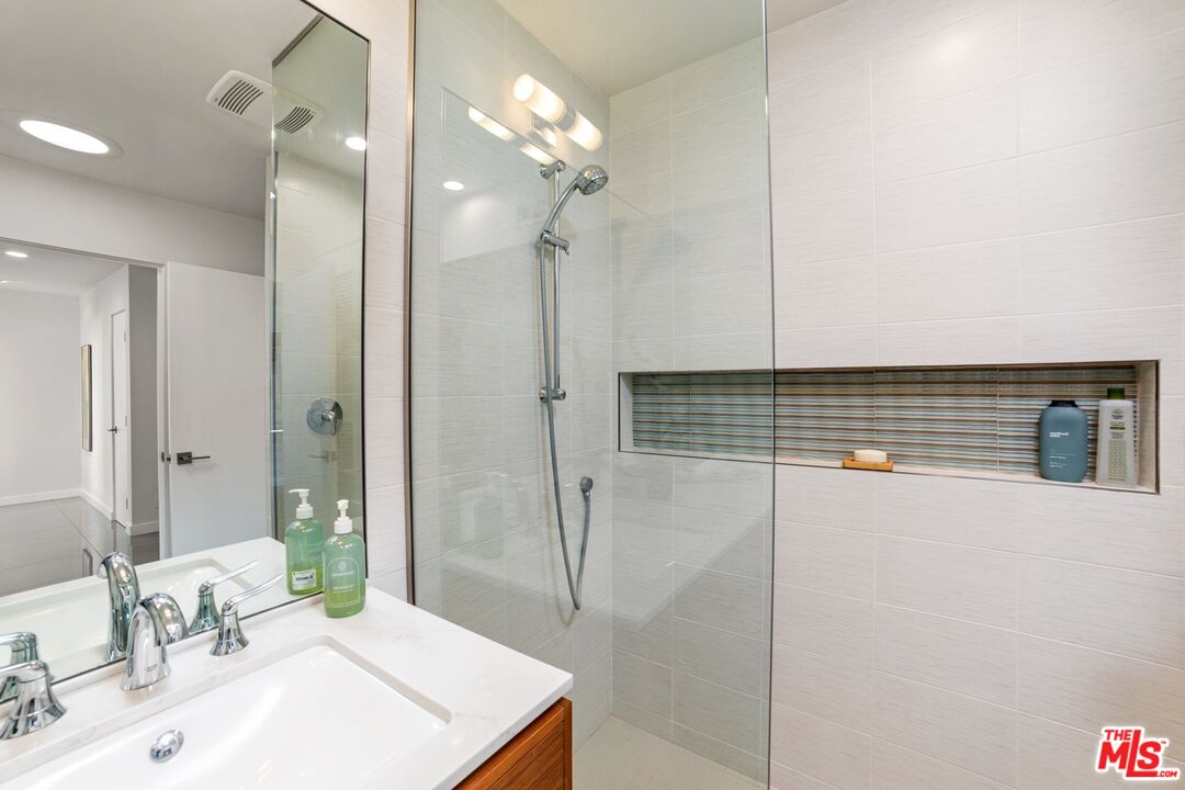 975 East Sunny Dunes Road Palm Springs, CA 92264 - Photo 18 of 40 a bathroom with a sink a mirror and shower