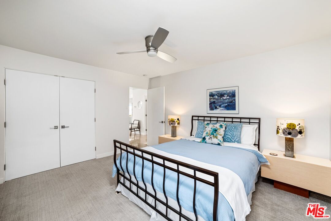 975 East Sunny Dunes Road Palm Springs, CA 92264 - Photo 20 of 40 a bedroom with a bed and a chandelier