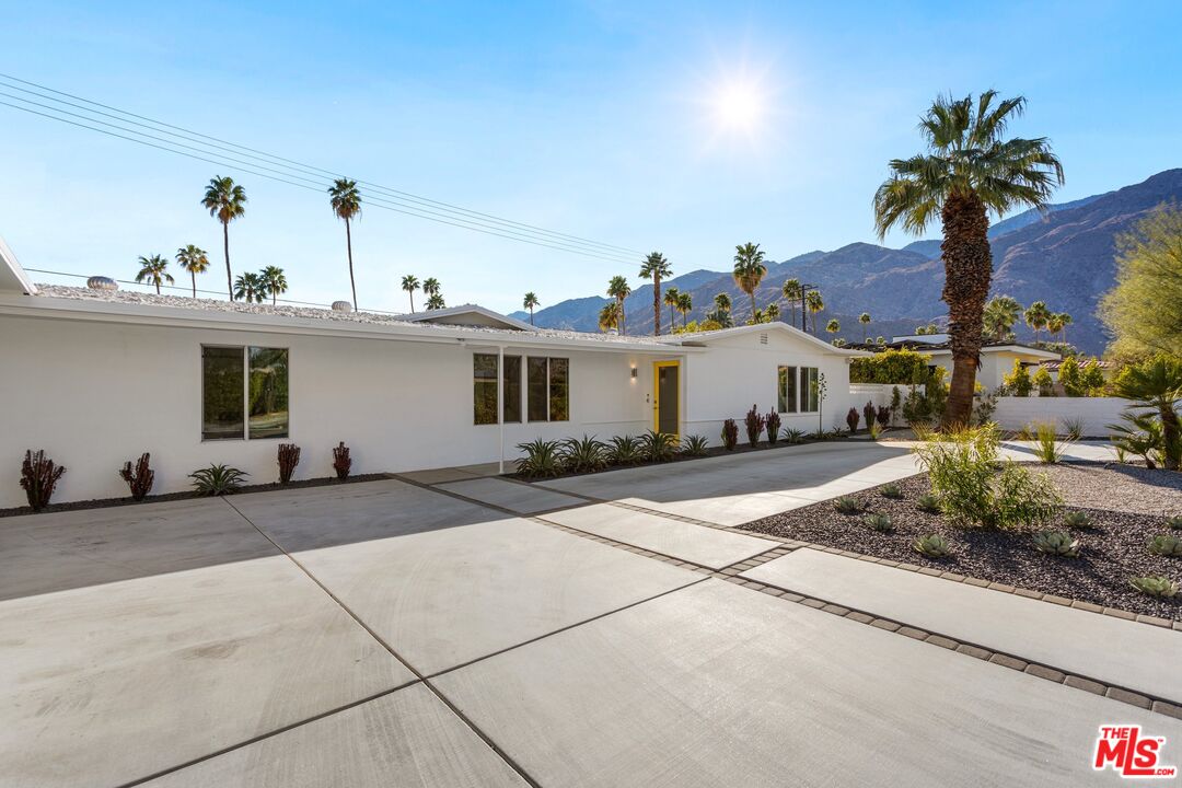 975 East Sunny Dunes Road Palm Springs, CA 92264 - Photo 2 of 40 a front view of a house with a yard and garage