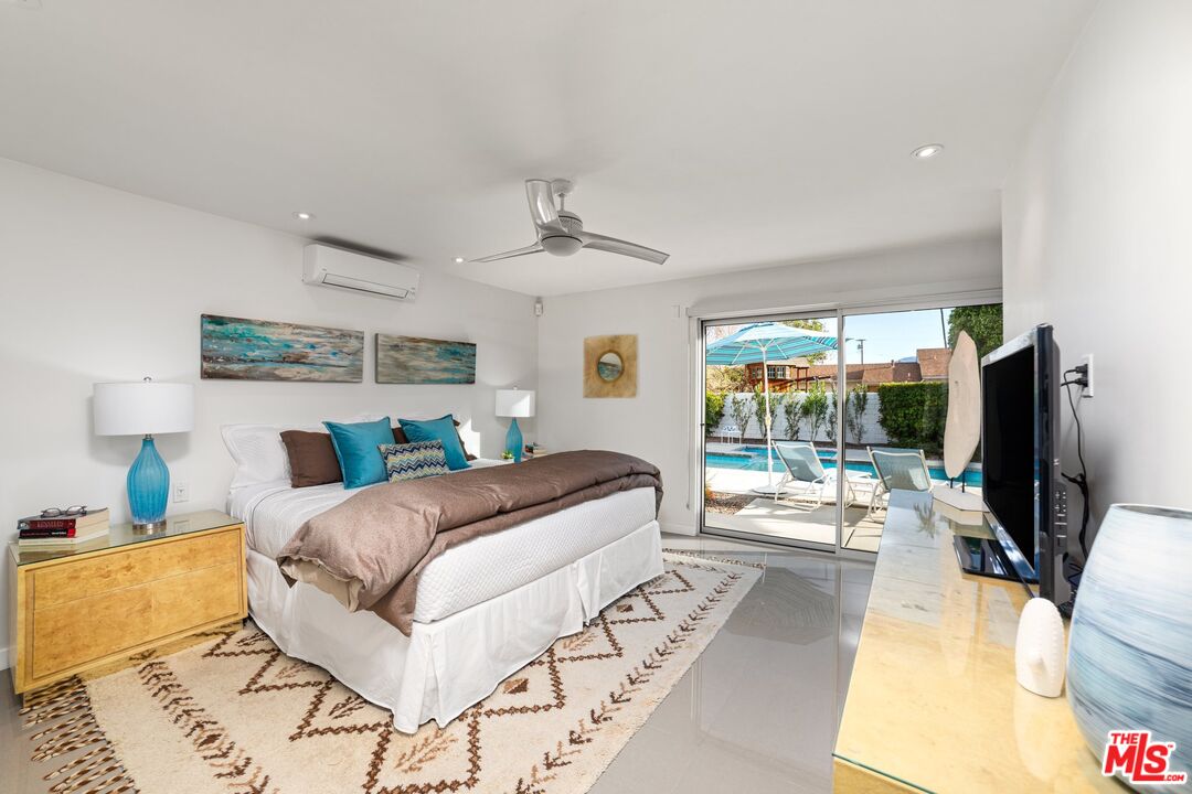 975 East Sunny Dunes Road Palm Springs, CA 92264 - Photo 22 of 40 a bedroom with a bed and large windows