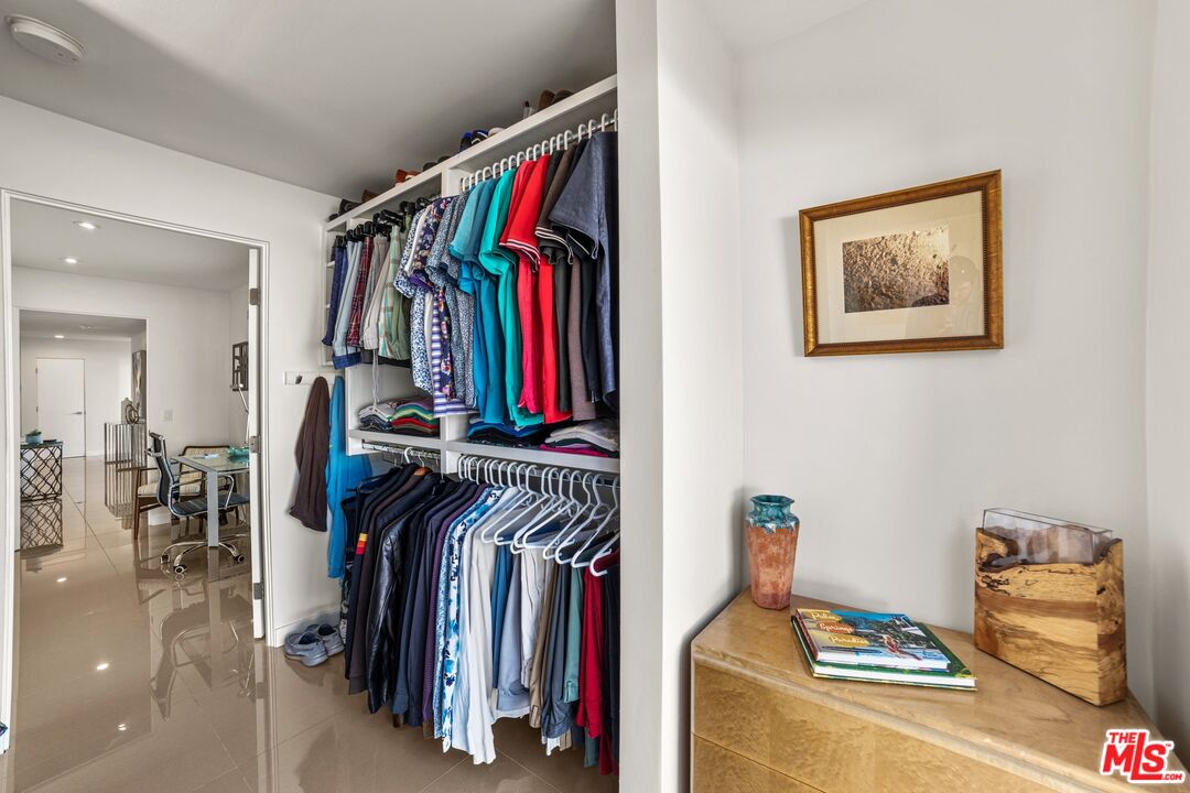975 East Sunny Dunes Road Palm Springs, CA 92264 - Photo 25 of 40 a view of walk in closet with clothes and shoes