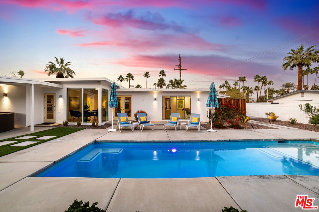 975 East Sunny Dunes Road Palm Springs, CA 92264 - Photo 32 of 40 a view of a house with swimming pool and sitting area