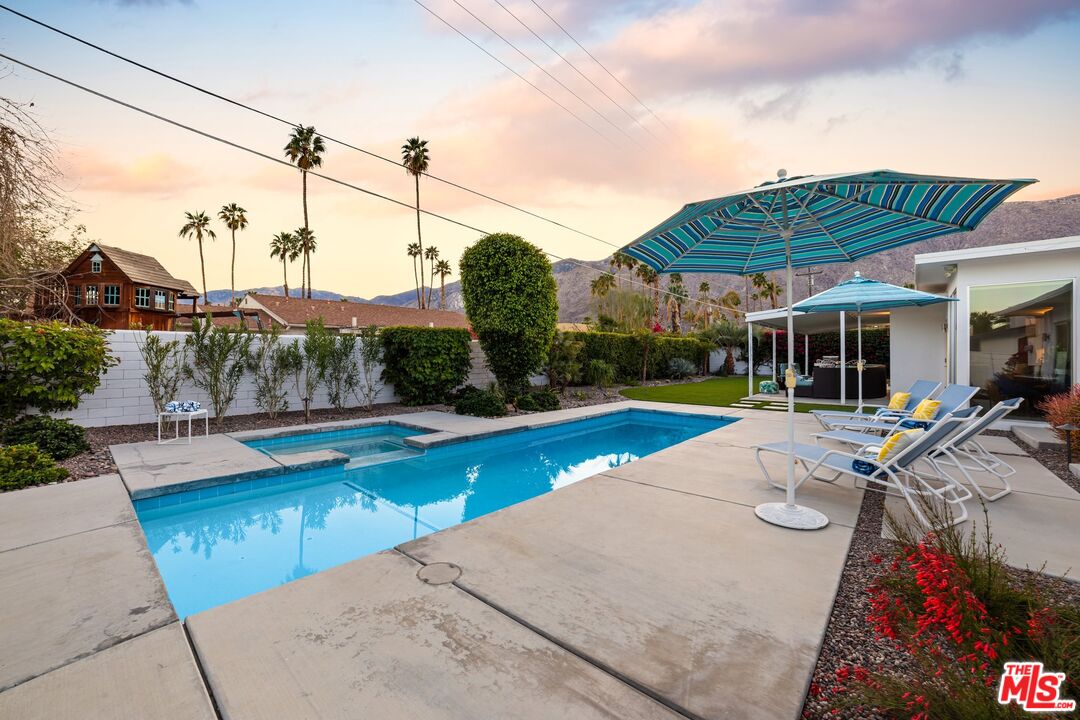 975 East Sunny Dunes Road Palm Springs, CA 92264 - Photo 33 of 40 a view of a swimming pool with lounge chairs