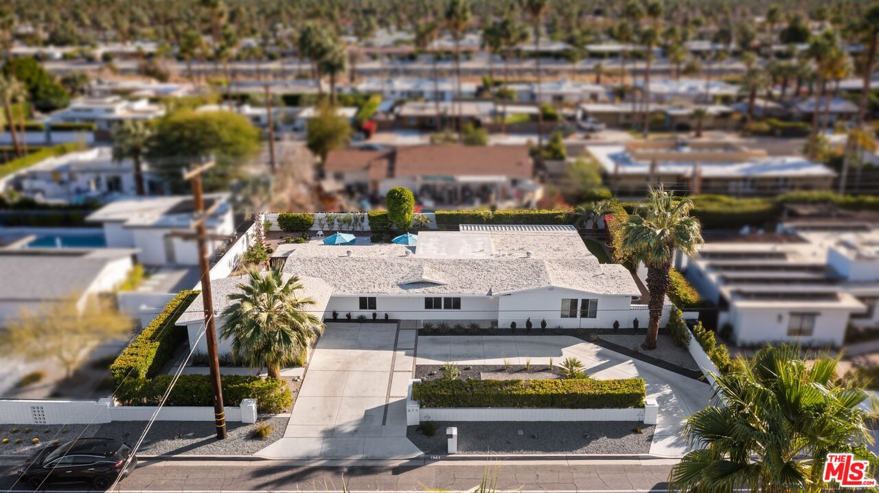 975 East Sunny Dunes Road Palm Springs, CA 92264 - Photo 38 of 40 a view of a swimming pool with outdoor seating and plants