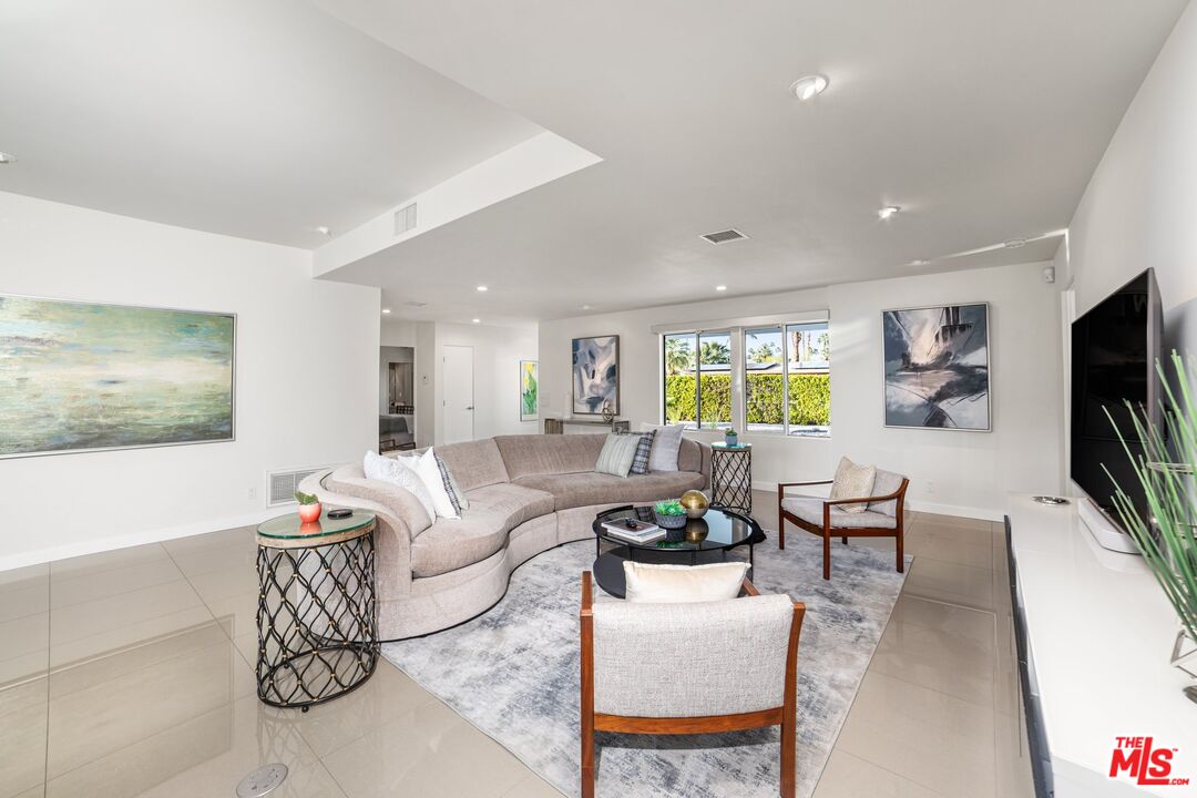 975 East Sunny Dunes Road Palm Springs, CA 92264 - Photo 8 of 40 a living room with furniture flat screen tv and window