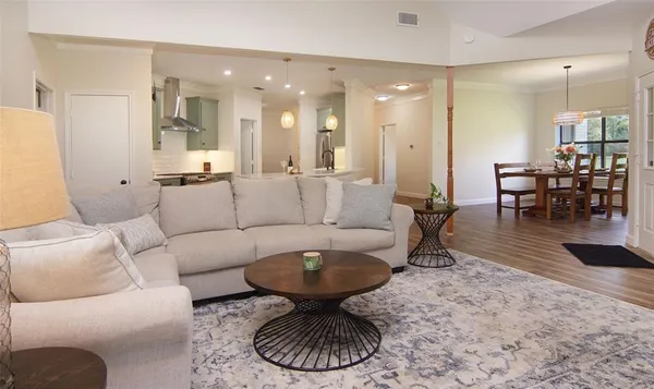 a living room with furniture and a dining table