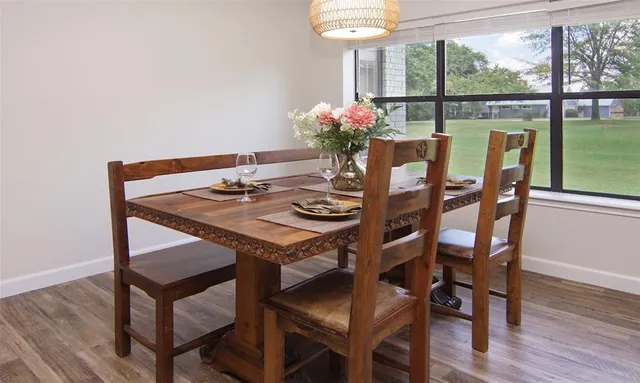 a dining room with furniture and window